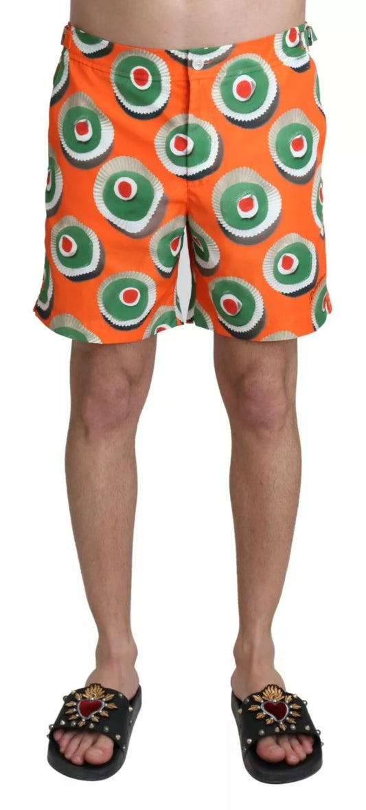 Men's swim trunks with a pattern of green bullseyes on an orange background