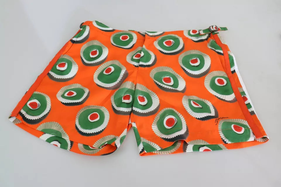 Shorts with red background and green and white circular patterns