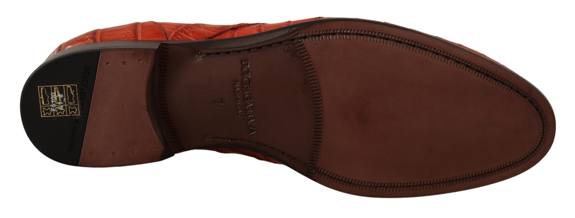 Brown leather dress shoe with laces and a small tag on the tongue