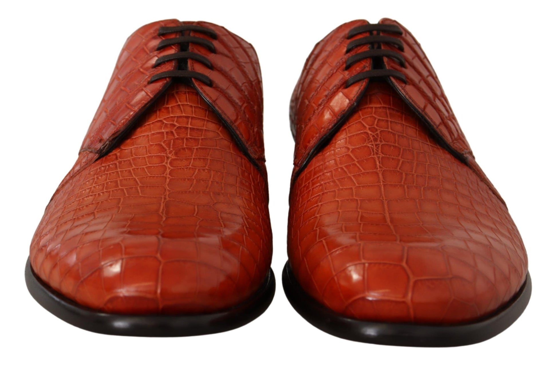 Pair of red leather shoes with laces and a strap across the top