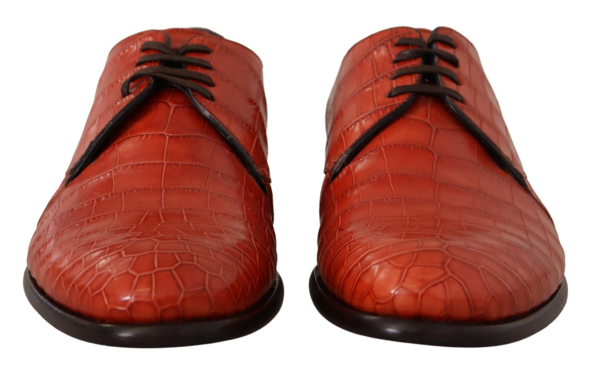 Pair of red leather shoes with laces and a strap across the top