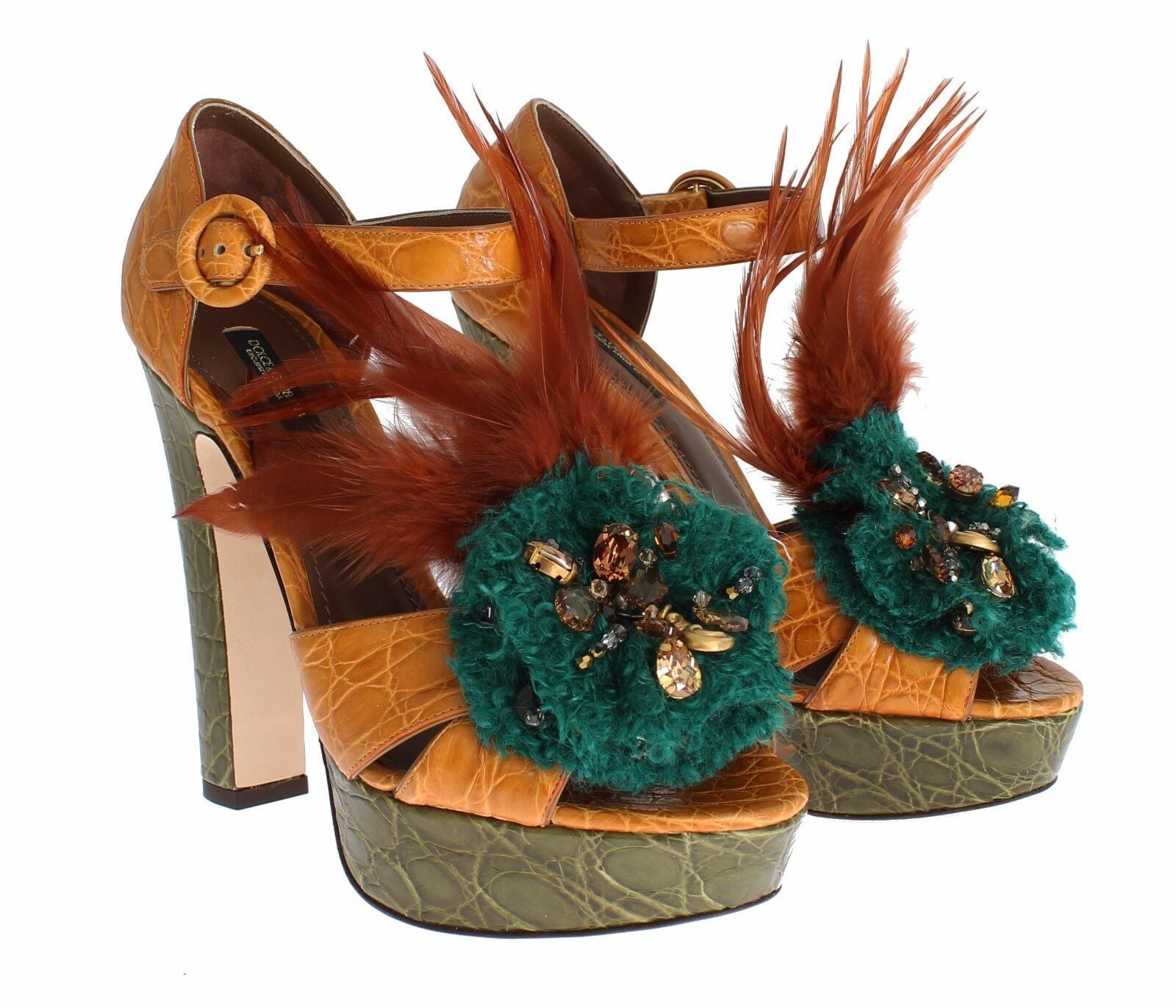 Pair of high heel shoes with feathered embellishments and ornate decorations on a white background