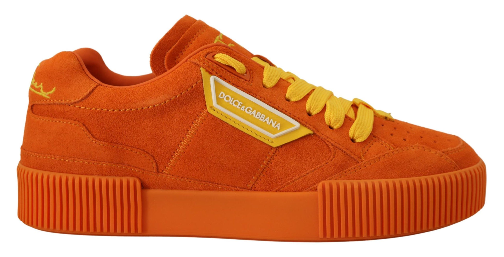 Orange sneakers with yellow laces and a white logo on side