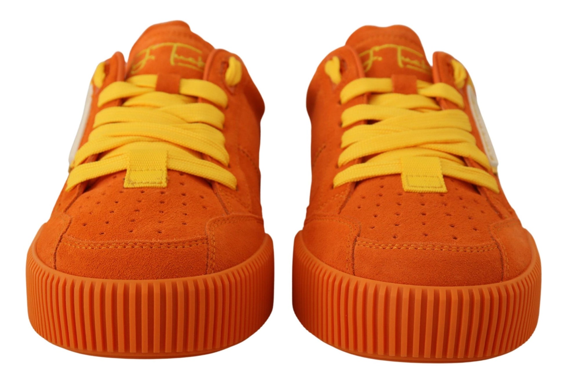 Pair of orange sneakers with yellow laces and white soles