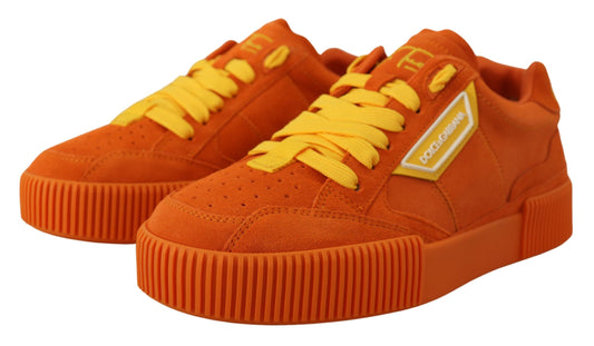 Pair of orange sneakers with yellow laces and white soles