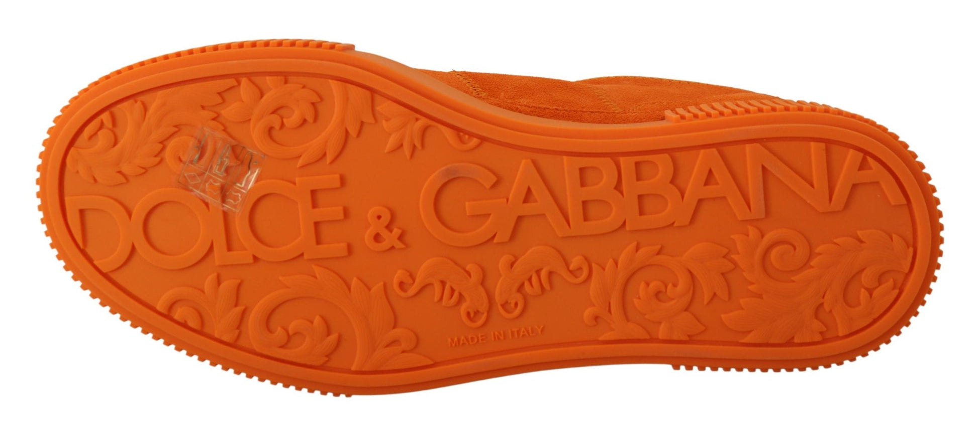 Orange shoe with embossed lettering and design on sole