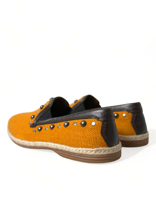 Pair of shoes with orange upper and black sole