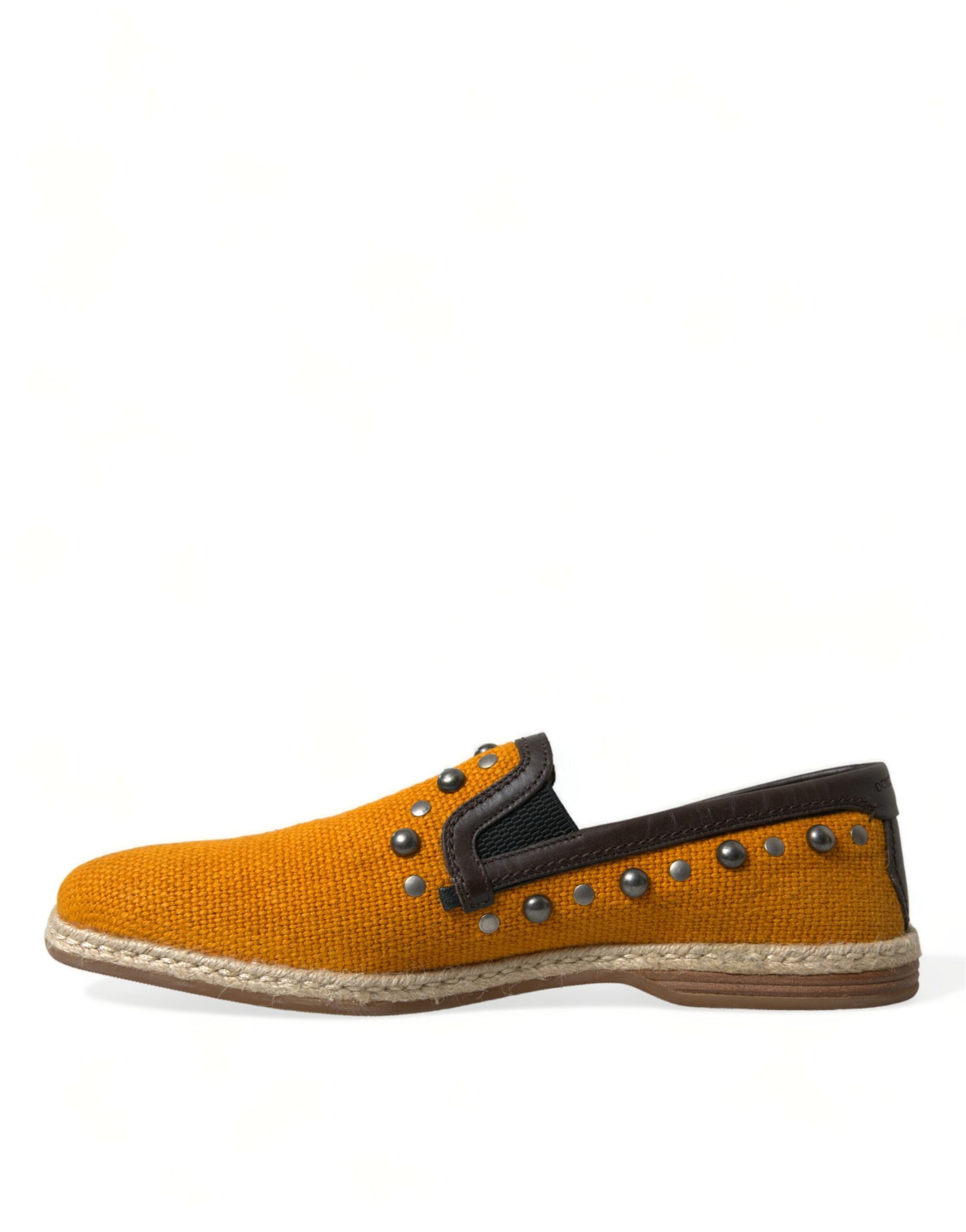 Yellow baby shoe with brown sole and orange laces