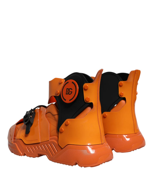Pair of orange boots with black straps and red accents