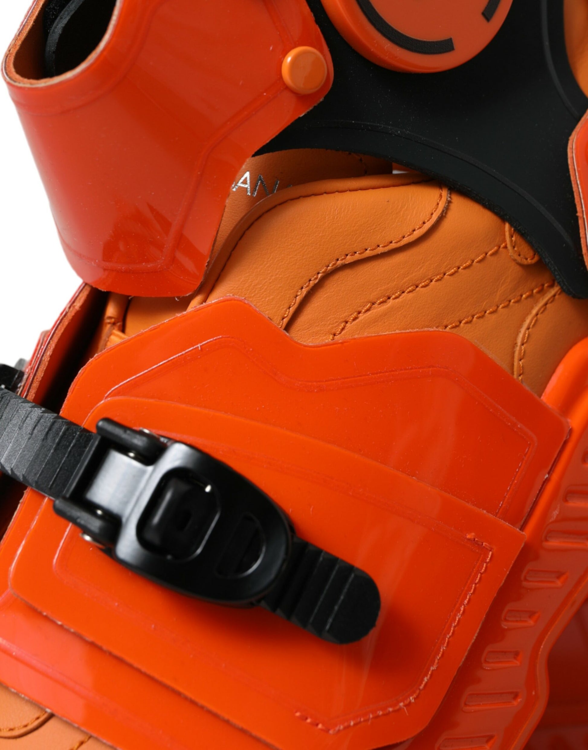 Orange and black shoe with laces, straps, and buckle