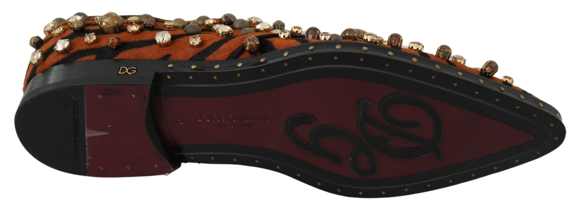 A single shoe against a neutral background. It appears to be a hiking or outdoor boot with a dark base color and decorati