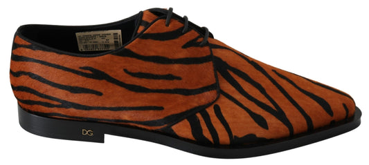 Pair of red shoes with black soles and tiger print design