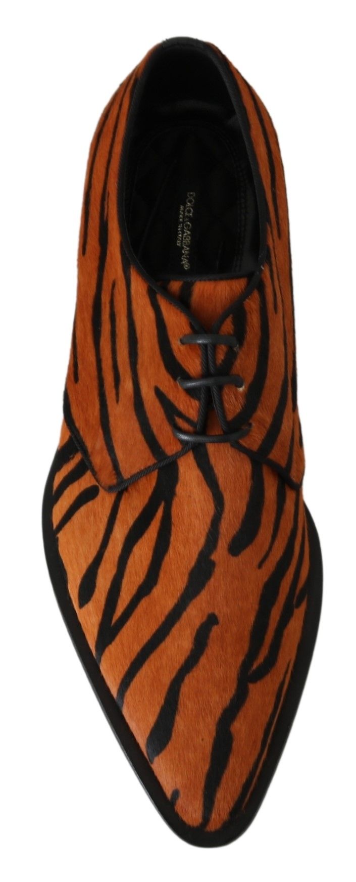 Pair of orange and black tiger print shoes with laces