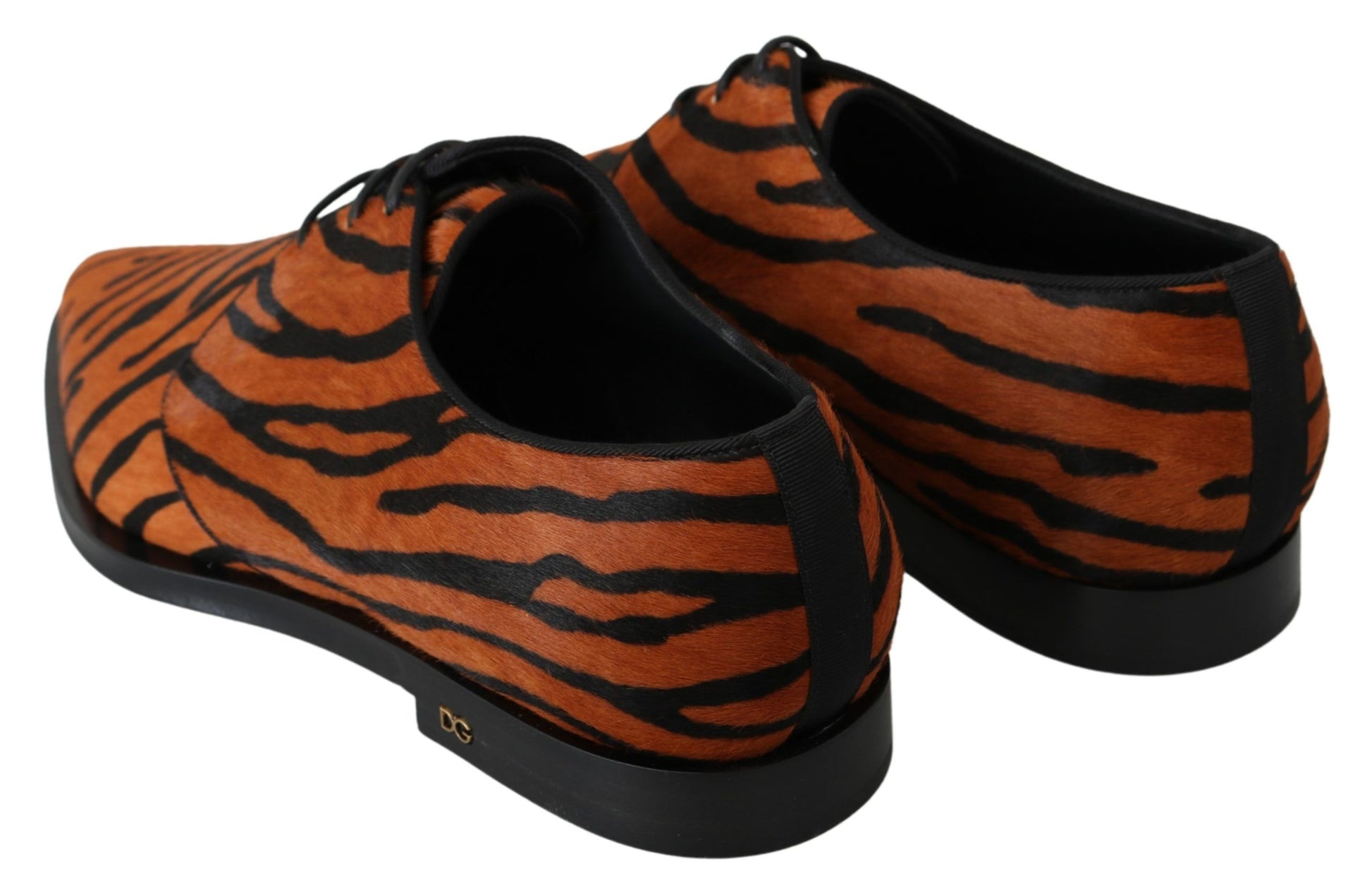 Pair of orange and black tiger print shoes with laces