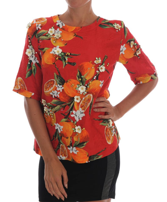 Woman wearing red floral top with orange flowers