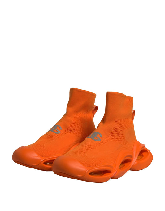Orange socks with black logo on heel