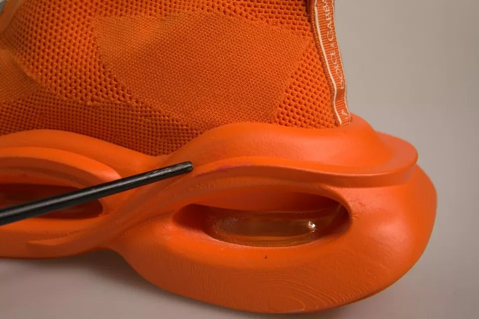 Orange athletic shoe with black laces