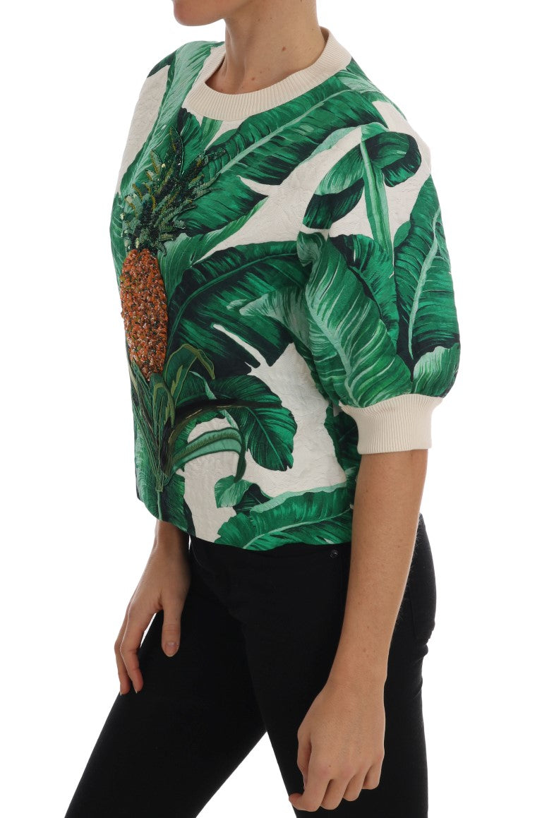 Woman wearing a long sleeve sweater with tropical leaves design