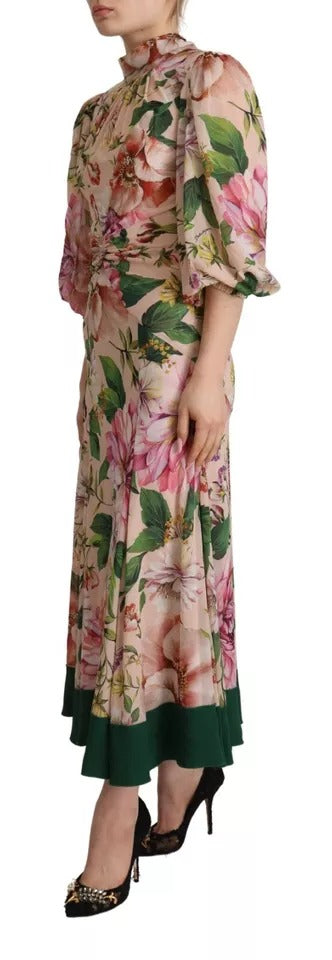 A long, pink floral dress with an A-line silhouette and a pussy bow at the neck. It features a sheath style d