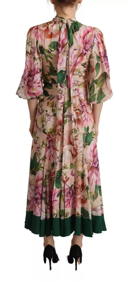 A long, pink floral dress with an A-line silhouette and a pussy bow at the neck