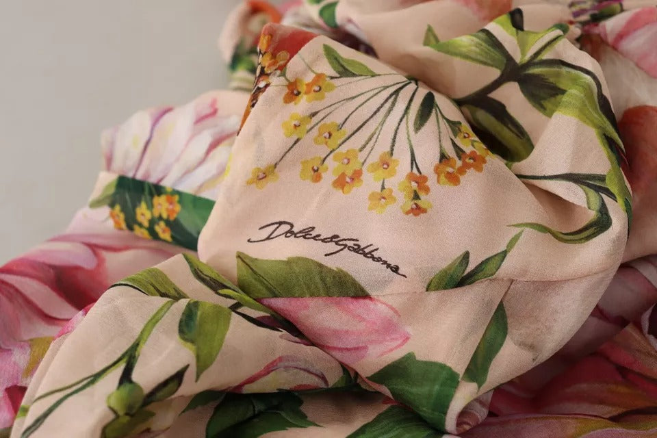 A pink floral print dress with a bow at the neckline