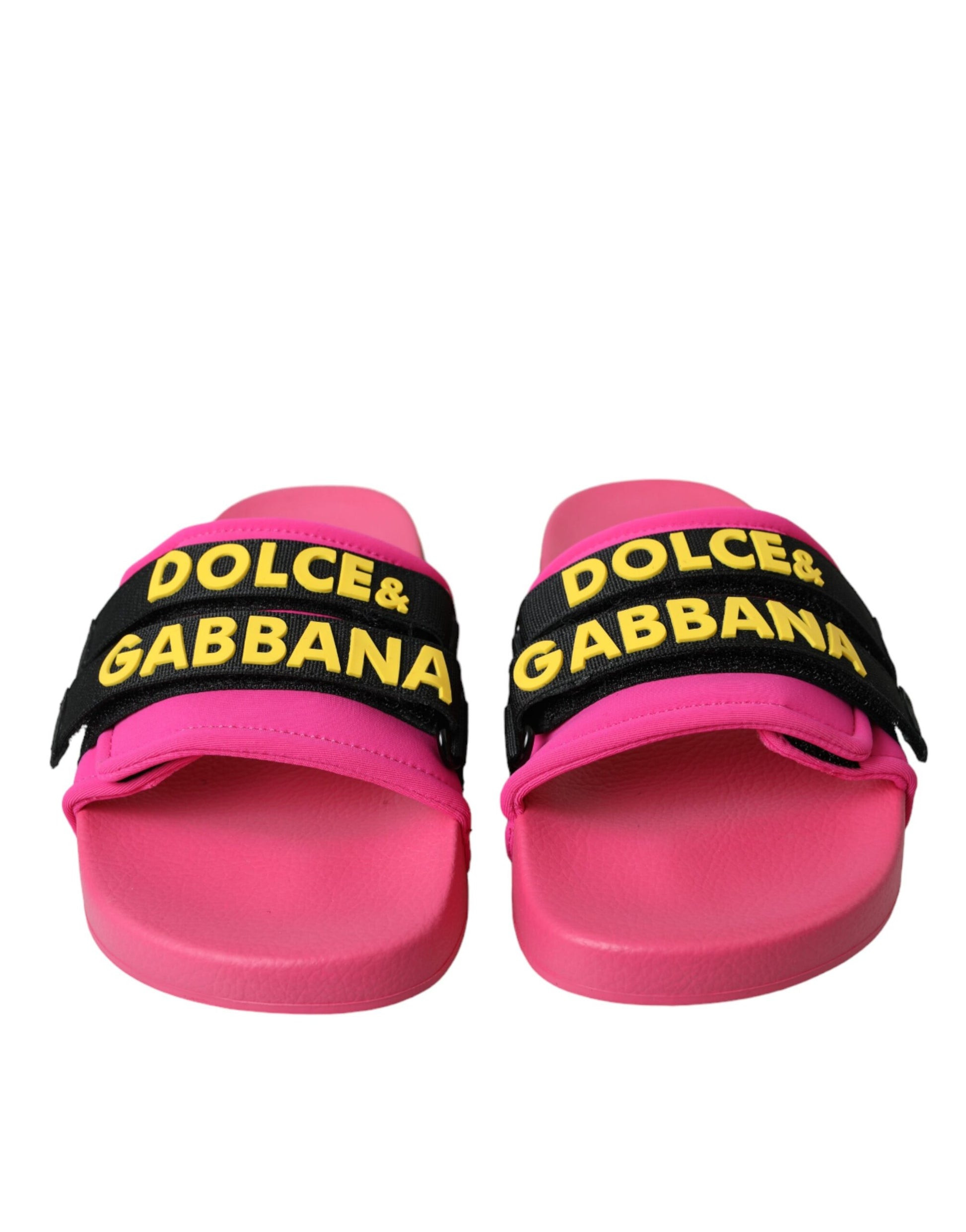 Pair of pink flip flops with yellow brand names