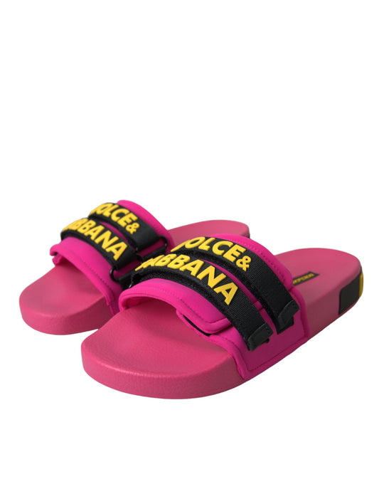 Pink flip flops with black straps and yellow lettering