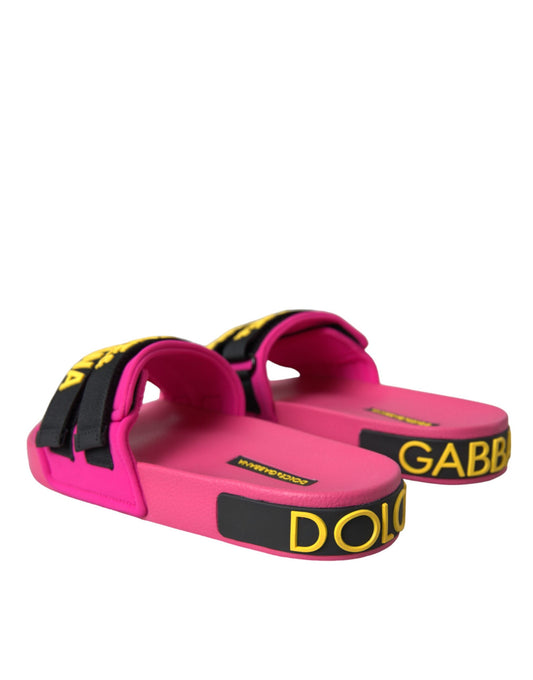 Pink flip flops with black straps and yellow lettering