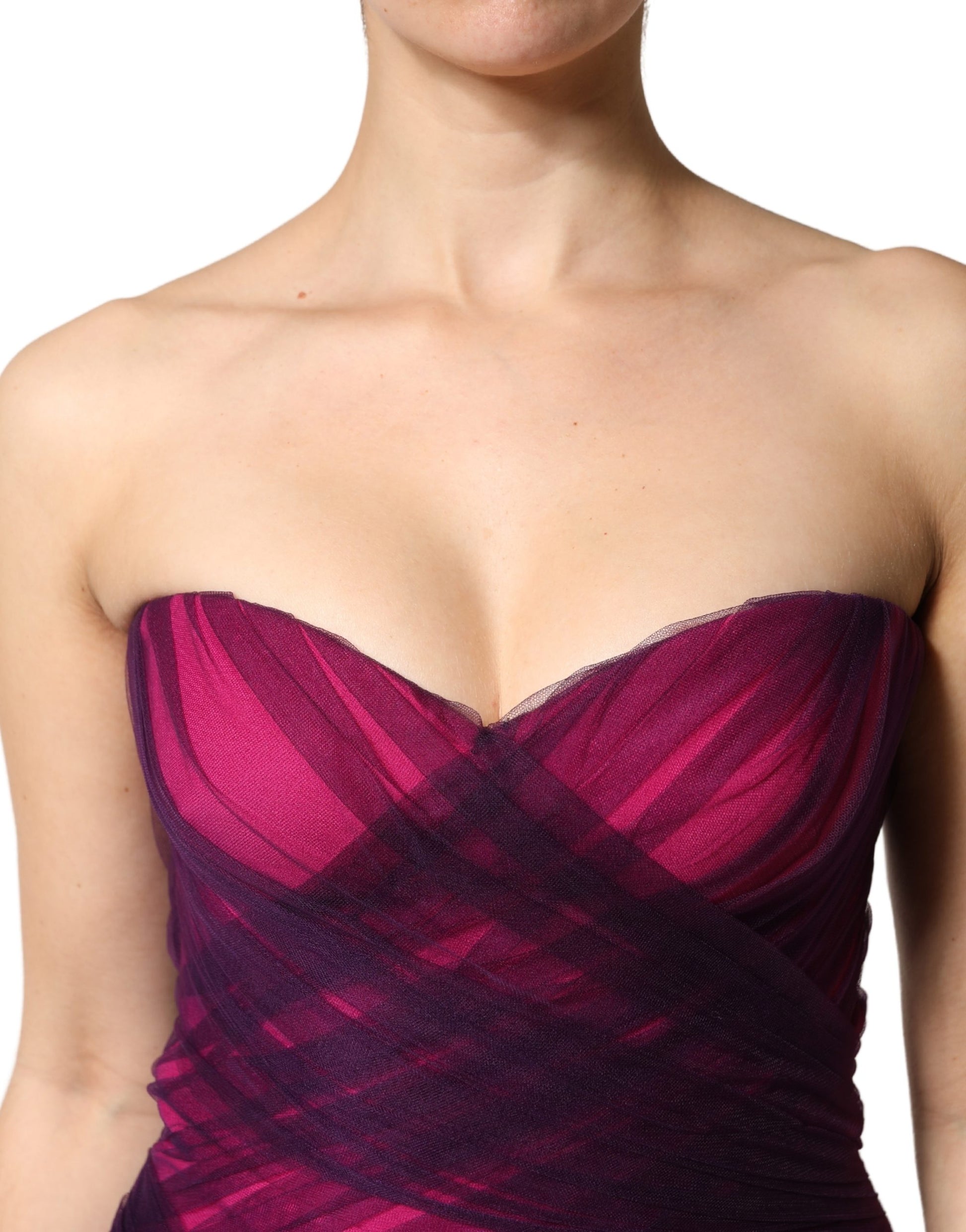 A strapless mermaid dress in pink and black with a sheer bodice
