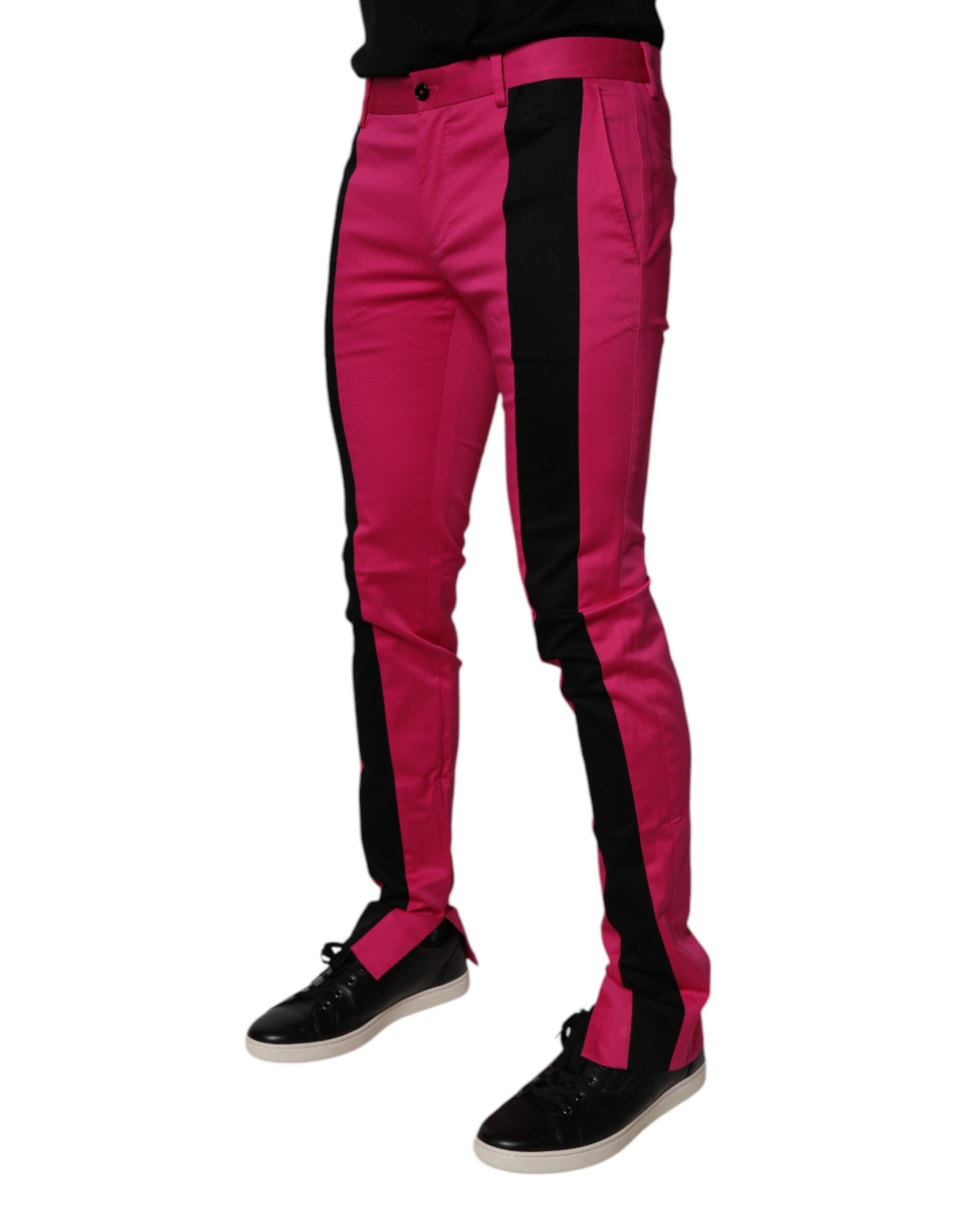 A pair of men's pants with a slim fit. They feature a bold pink and black striped pattern on the legs, which