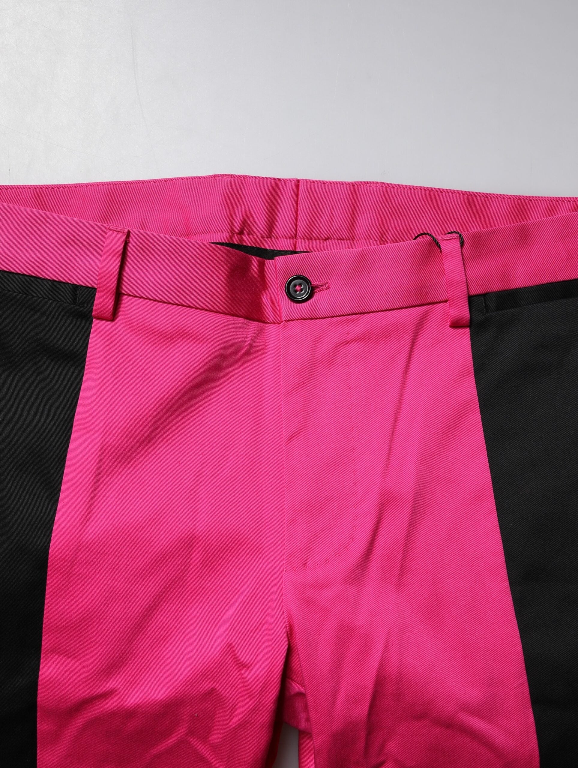 A pair of pink and black striped men's dress pants