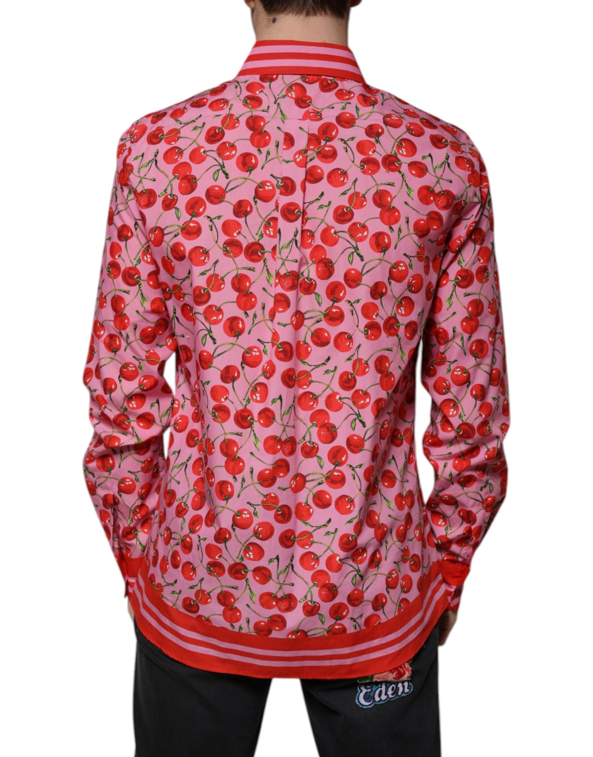 A pink shirt with cherry print and red trim