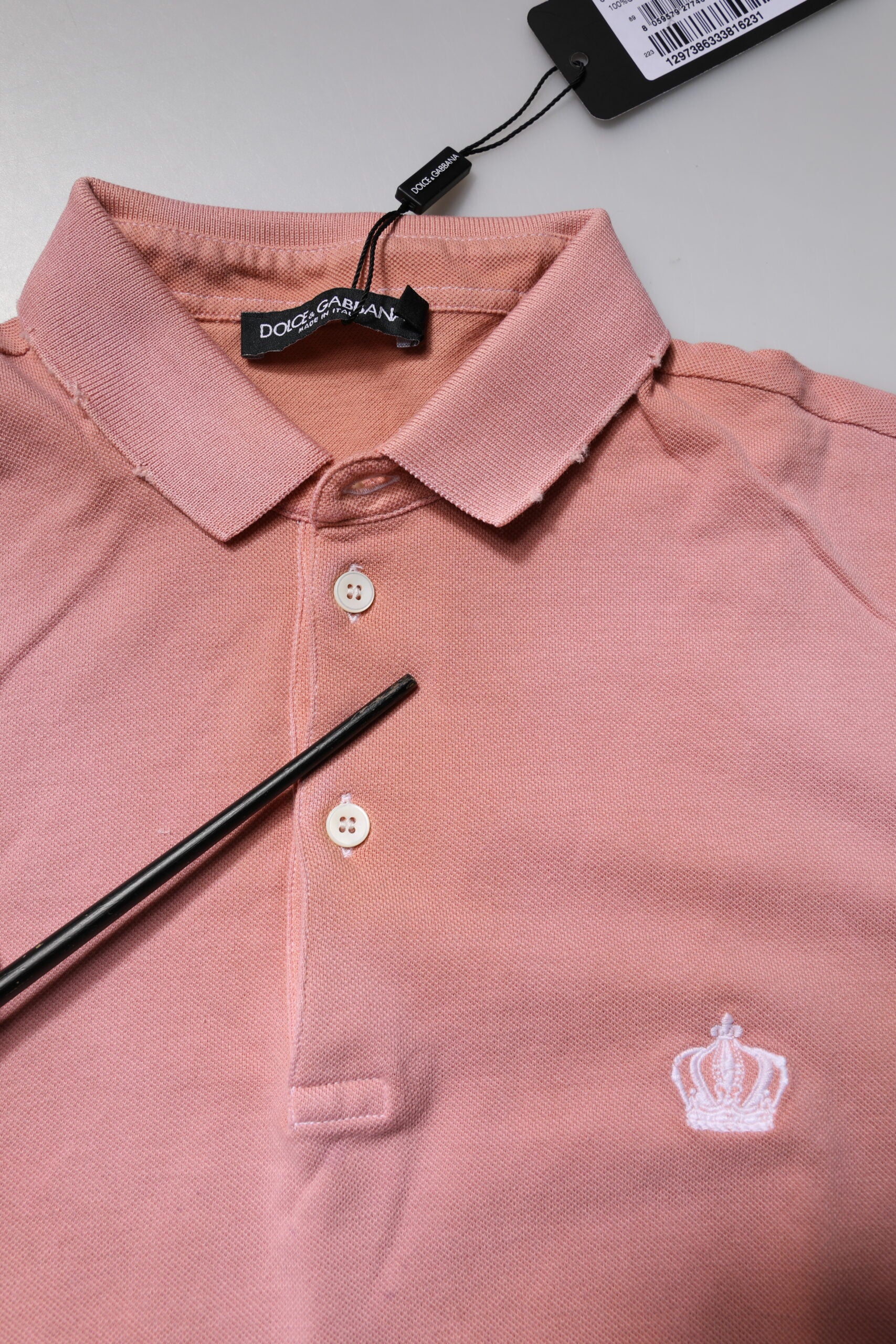 Pink polo shirt on hanger with tag