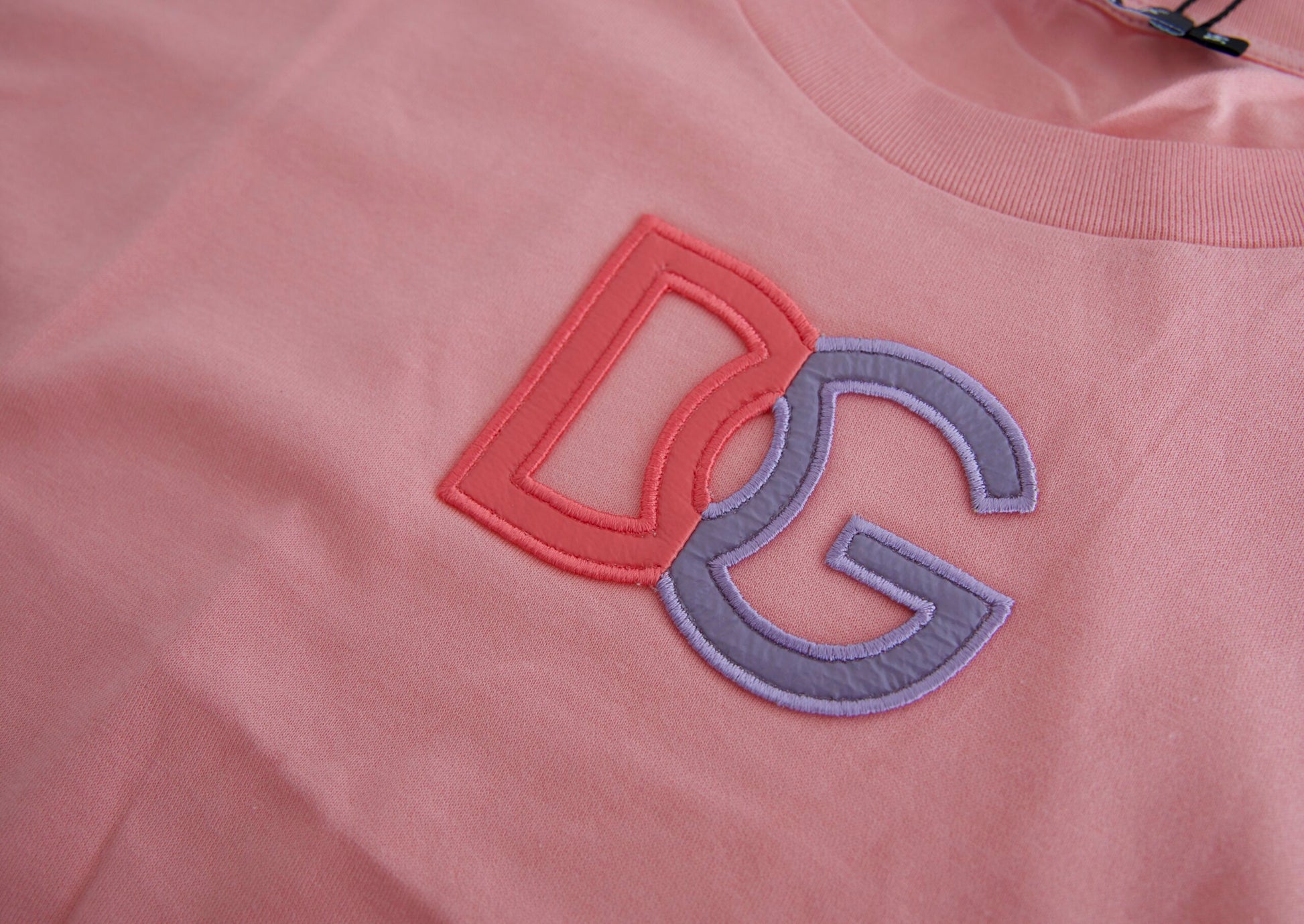 Pink shirt with red letters DDG