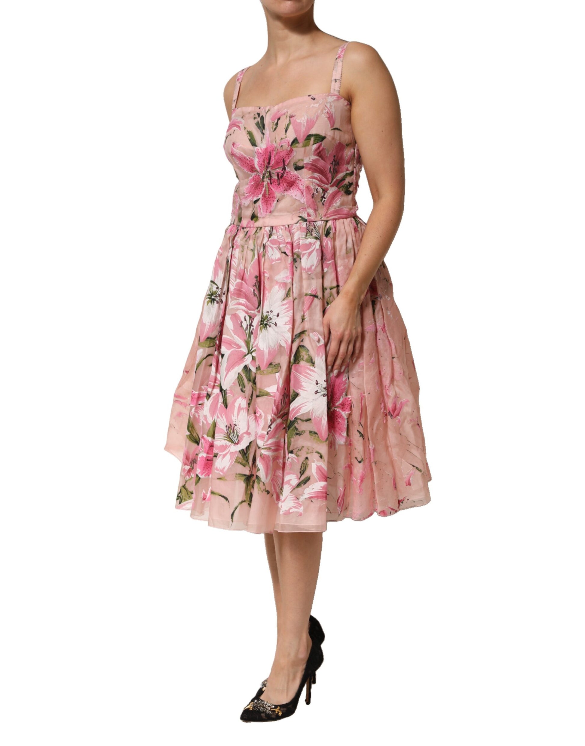 A pink floral pleated dress with short sleeves, worn by a model