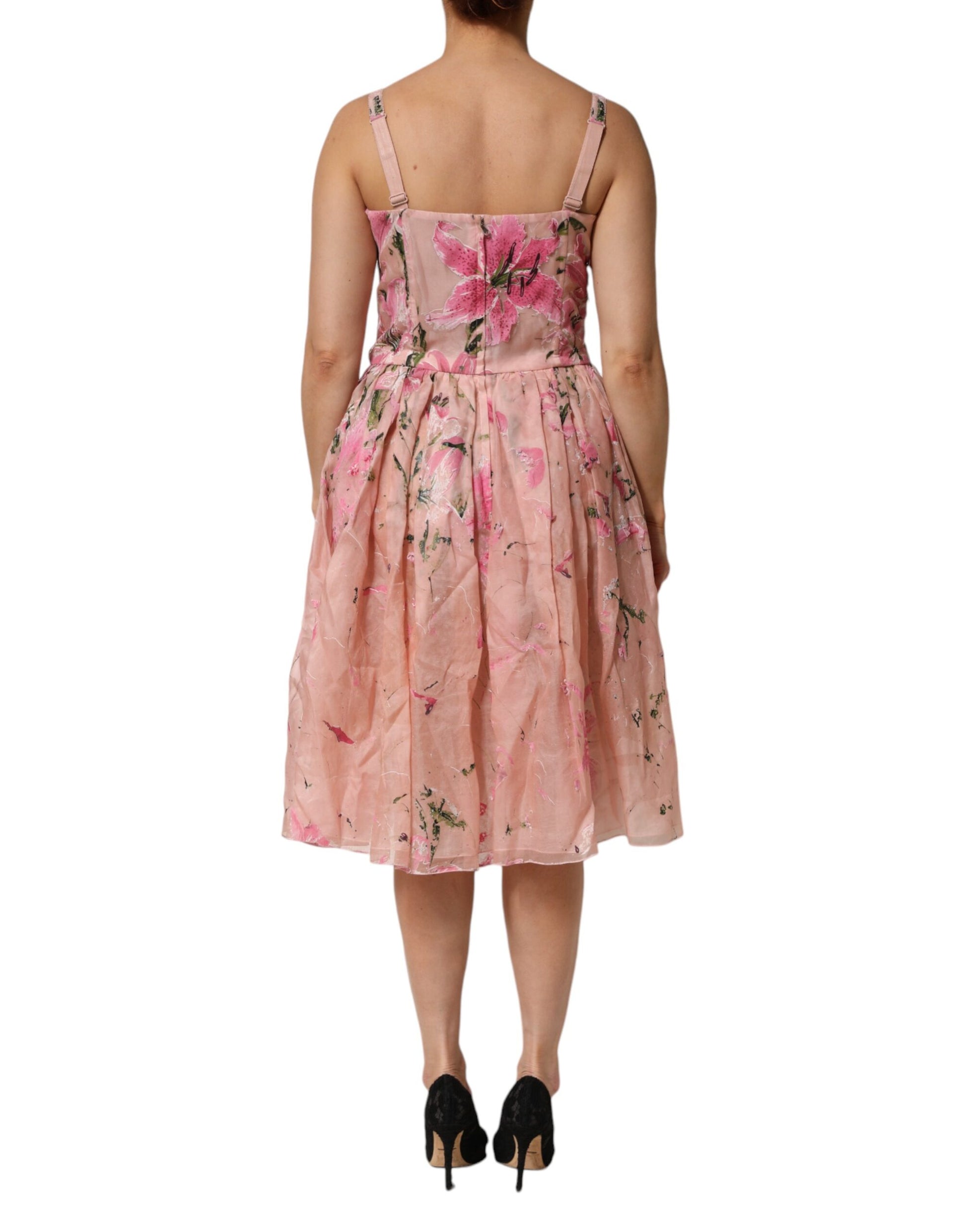 A pink floral pleated dress with short sleeves and a fitted waist