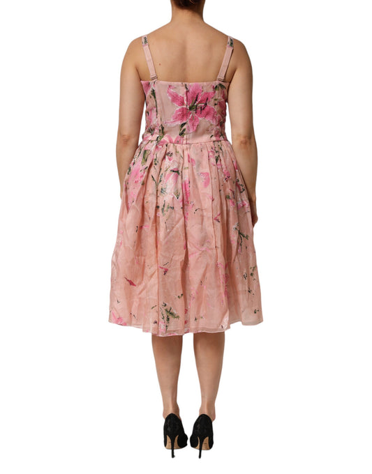 A pink floral pleated dress with short sleeves and a fitted waist