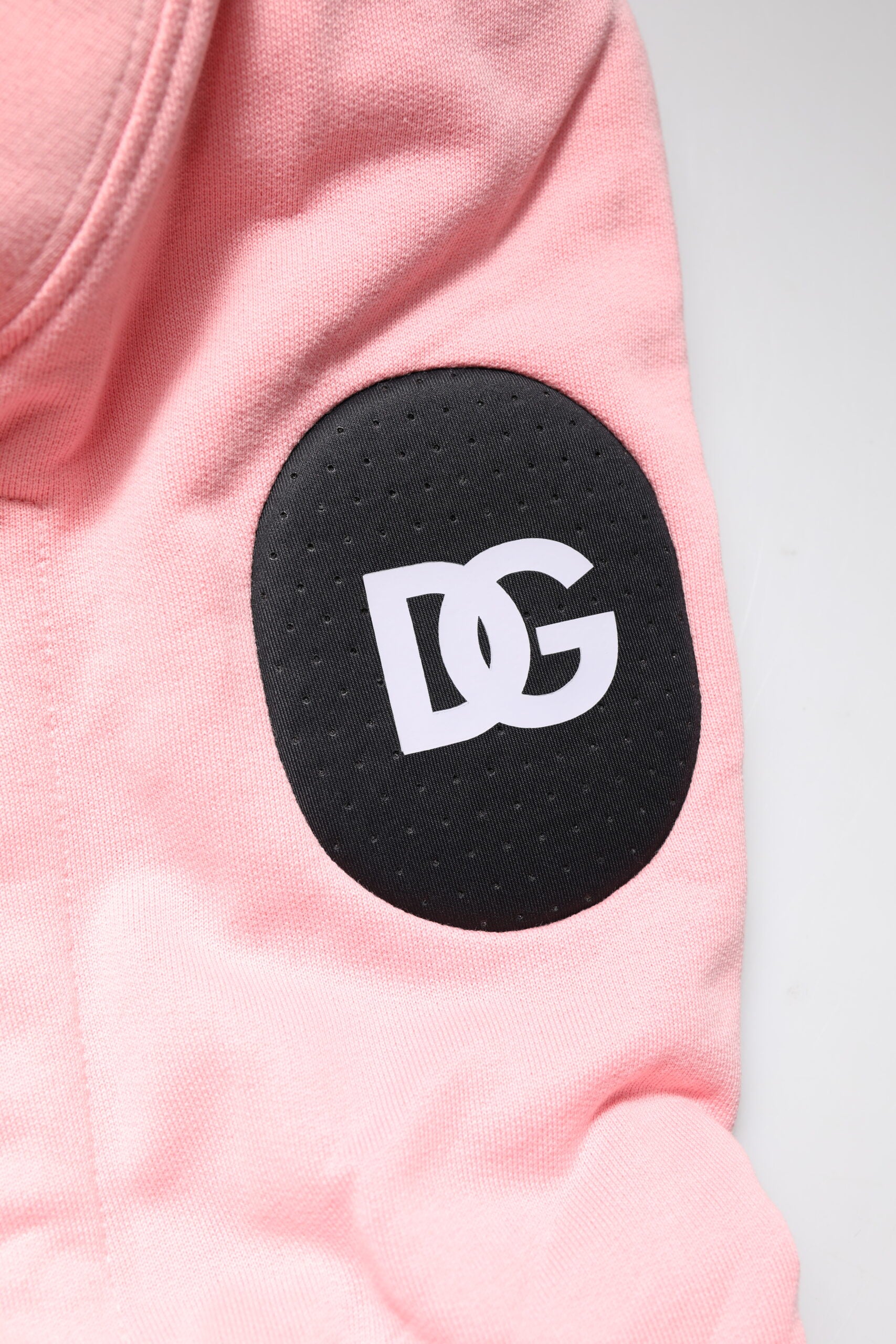 Pink shirt with black logo on sleeve