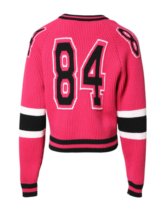 Pink sweater with red lettering and black trim