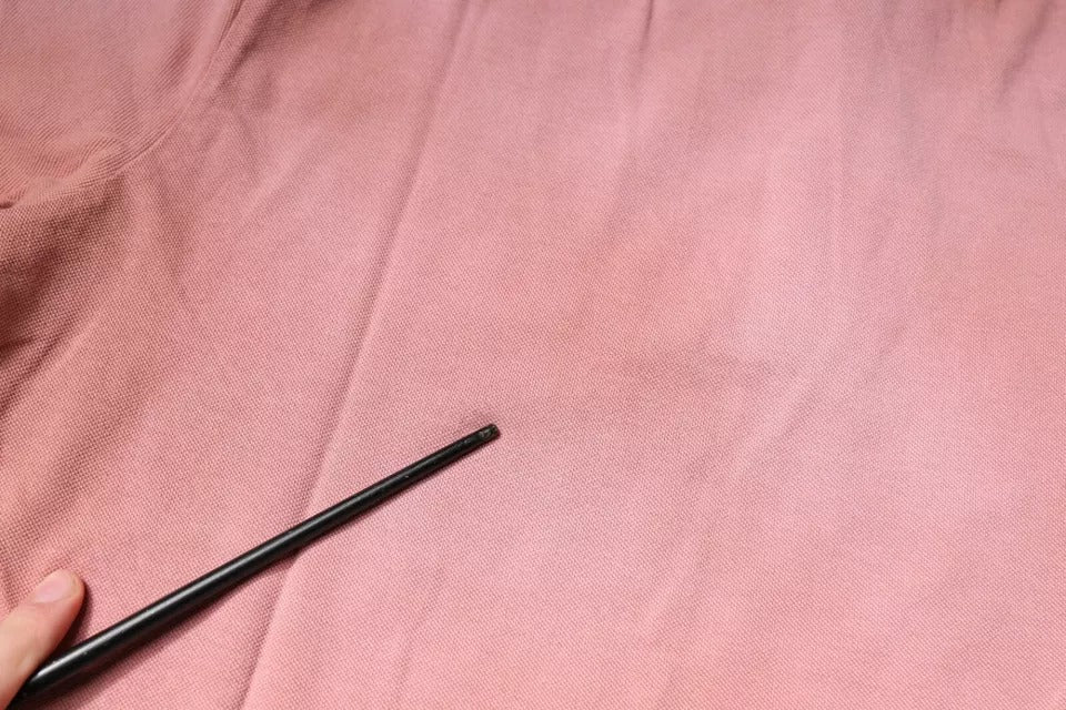 Black pen on pink fabric