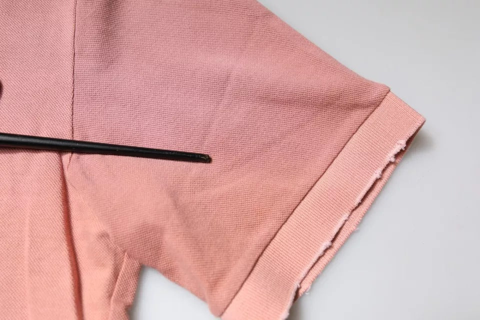 Pink fabric with black pin in middle