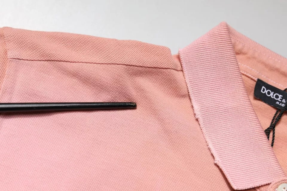 Pink shirt on hanger with black tie clip