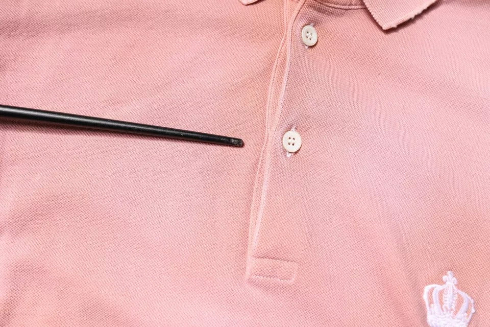 Pink polo shirt with black buttons