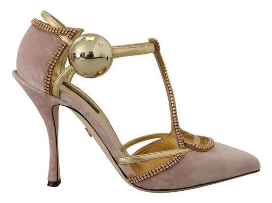 Pink high heel shoe with gold accents and a large ball on top of the toe