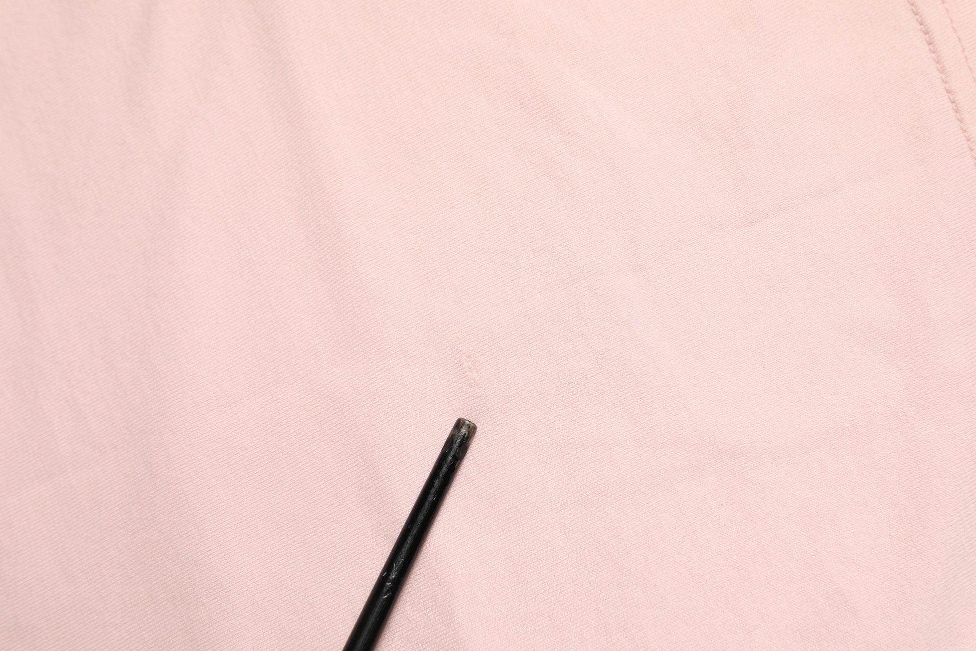 Black pen on pink fabric