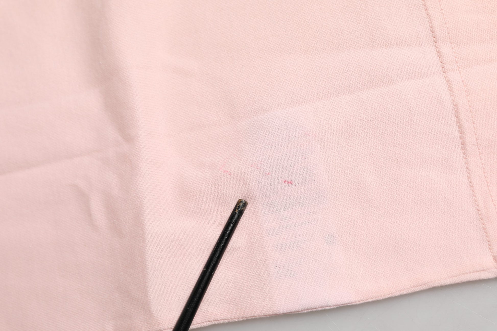 Pink cloth with black markings on it
