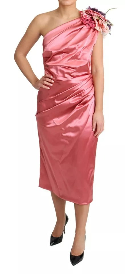A pink draped midi dress with floral applique detailing