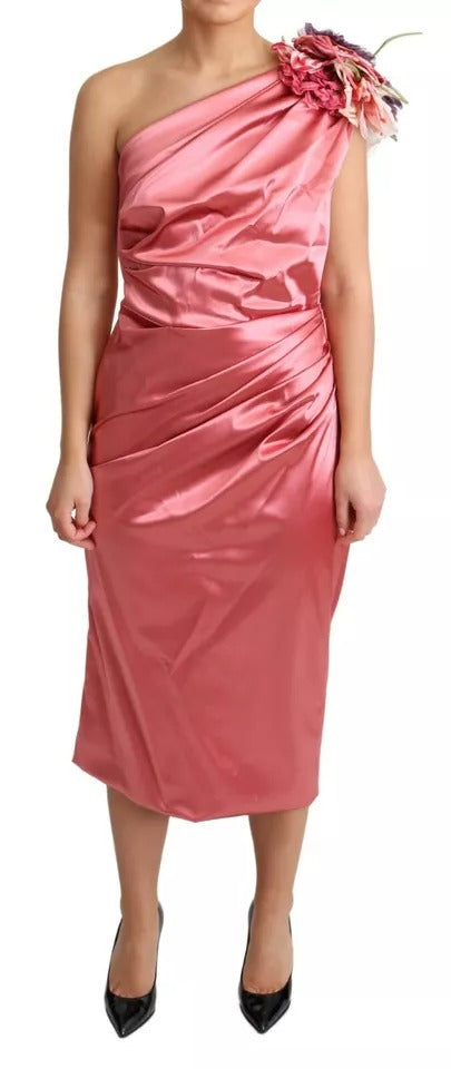 A pink draped midi dress with flower applique detailing from the brand Dolce & Gabbana