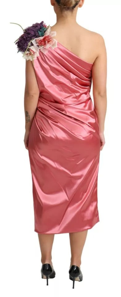 A pink draped midi dress with floral applique detailing