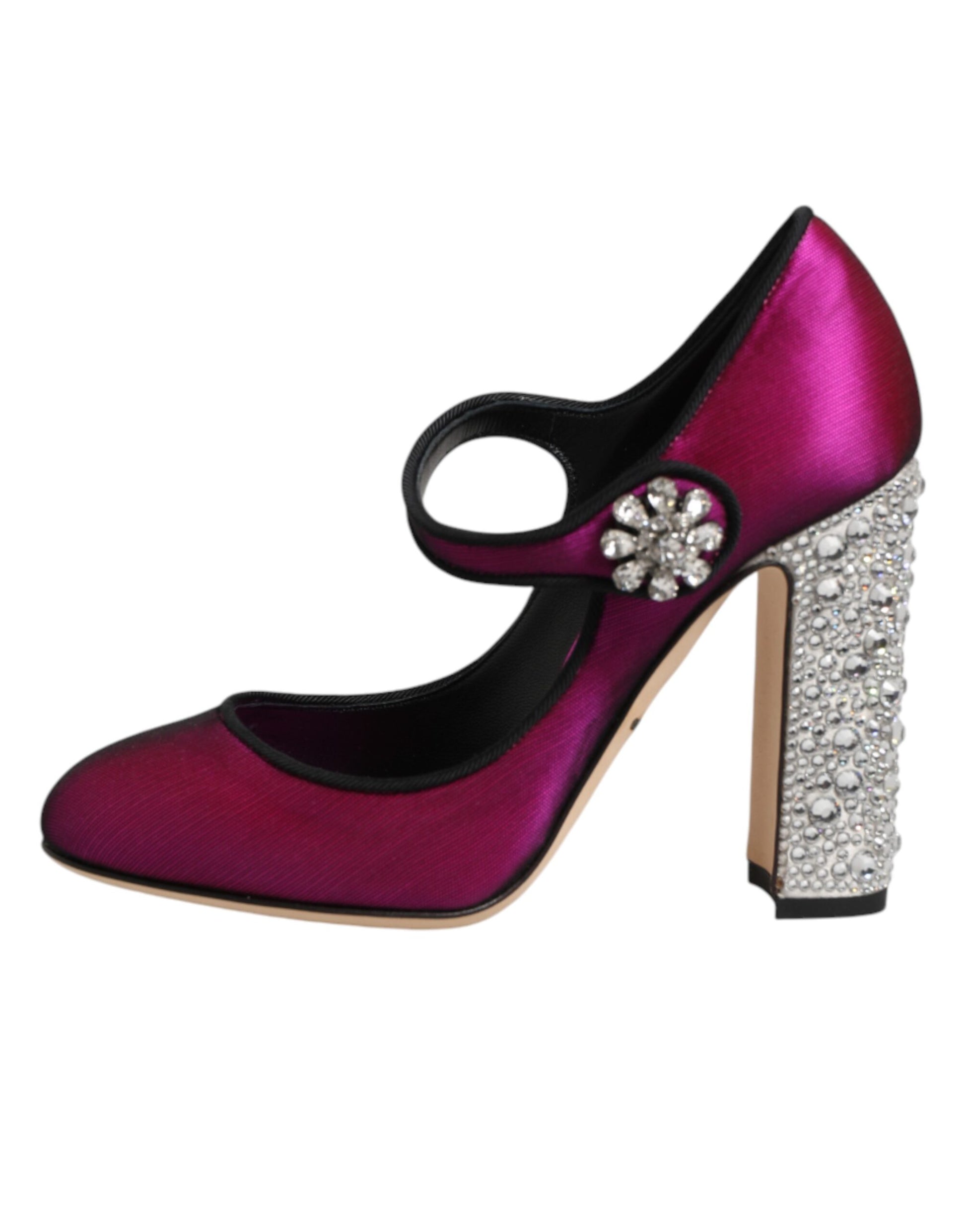 Pair of pink high heel shoes with rhinestones on toe